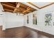 Bright dining room with hardwood floors, beamed wood ceiling, wainscoting and natural light at 2539 Larson Creek Cove, Duluth, GA 30097