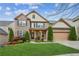 Charming two-story brick home with lush landscaping, a two-car garage, and inviting curb appeal at 2539 Larson Creek Cove, Duluth, GA 30097