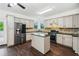 Modern kitchen with stainless steel appliances, an island, dark countertops, and tiled backsplash at 2539 Larson Creek Cove, Duluth, GA 30097
