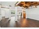 Spacious living room with hardwood floors, beamed wood ceiling, and wainscoting at 2539 Larson Creek Cove, Duluth, GA 30097