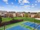 An aerial view of the neighborhood with tennis courts and greenery in the background at 2539 Larson Creek Cove, Duluth, GA 30097