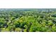Aerial view of wooded property shows a canopy of mature trees with a glimpse of the home below at 3046 Valley Cir, Decatur, GA 30033