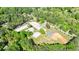 Overhead view featuring community buildings and a tennis court surrounded by mature trees at 3046 Valley Cir, Decatur, GA 30033