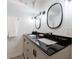 Bathroom featuring a dual sink vanity, modern mirrors and patterned floor tiles at 3046 Valley Cir, Decatur, GA 30033