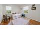 Bedroom featuring hardwood floors, ample sunlight, and rocking chair at 3046 Valley Cir, Decatur, GA 30033