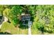 Aerial view of the home features mature trees, a well maintained lawn, and a driveway leading to a one car garage at 3046 Valley Cir, Decatur, GA 30033