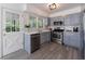 Updated kitchen features stainless steel appliances, stone countertops and a door to the outside at 3046 Valley Cir, Decatur, GA 30033