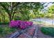 Brick steps framed by vibrant azaleas, leads to lush landscape; offering natural beauty and inviting curb appeal at 3046 Valley Cir, Decatur, GA 30033