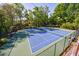 Dual tennis courts offer an amenity surrounded by trees and fenced in for privacy and recreational enjoyment at 3046 Valley Cir, Decatur, GA 30033