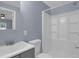 Bathroom with updated vanity, sink, toilet, and shower over tub at 5942 Morgan Rd, Atlanta, GA 30340