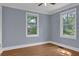 Bright bedroom with hardwood floors, trim, and two sunny windows with views at 5942 Morgan Rd, Atlanta, GA 30340