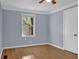 Inviting bedroom with hardwood floors, modern ceiling fan, and a bright window at 5942 Morgan Rd, Atlanta, GA 30340