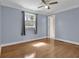 Bedroom with hardwood floors, neutral paint, and a sunny window at 5942 Morgan Rd, Atlanta, GA 30340