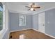 Cozy bedroom with hardwood floors, a ceiling fan, and bright window at 5942 Morgan Rd, Atlanta, GA 30340
