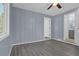 Bedroom with wood look floors, view of the ensuite bathroom, and natural light at 5942 Morgan Rd, Atlanta, GA 30340