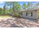 Single-story home with light gray siding, dark shutters, and a spacious driveway at 5942 Morgan Rd, Atlanta, GA 30340