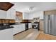 Kitchen featuring white cabinets, stainless steel appliances, and black countertops at 5942 Morgan Rd, Atlanta, GA 30340