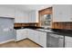 Traditional kitchen with white cabinets, stainless steel appliances, and a window view at 5942 Morgan Rd, Atlanta, GA 30340