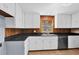 Kitchen featuring white cabinets, stainless steel appliances, and wood paneling at 5942 Morgan Rd, Atlanta, GA 30340