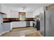 Kitchen featuring white cabinets, stainless steel appliances, and tile floors at 5942 Morgan Rd, Atlanta, GA 30340