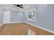 Bright, neutral living room with hardwood floors and a ceiling fan at 5942 Morgan Rd, Atlanta, GA 30340