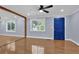 Bright living room with hardwood floors and a painted blue front door at 5942 Morgan Rd, Atlanta, GA 30340