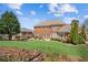Expansive backyard featuring lush green lawn and brick house at 5945 Boulder Bluff Dr, Cumming, GA 30040