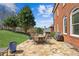 Brick home with a stone patio and ample outdoor seating at 5945 Boulder Bluff Dr, Cumming, GA 30040