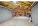 Unfinished basement featuring concrete walls, exposed wooden ceiling beams, and ample space for customization at 5945 Boulder Bluff Dr, Cumming, GA 30040