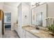 Bright bathroom features granite counters, white cabinets, stylish fixtures and pretty decor at 5945 Boulder Bluff Dr, Cumming, GA 30040