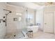 Beautiful bathroom featuring a free-standing tub, glass enclosed shower, and a decorative leaded glass window at 5945 Boulder Bluff Dr, Cumming, GA 30040