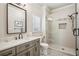 Updated bathroom featuring a glass shower, quartz countertops, stylish gray cabinets and patterned flooring at 5945 Boulder Bluff Dr, Cumming, GA 30040