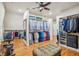 Large walk-in closet with hardwood floors, custom shelving and hanging storage space at 5945 Boulder Bluff Dr, Cumming, GA 30040