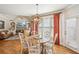 Dining area with hardwood floors, a fireplace, and natural light at 5945 Boulder Bluff Dr, Cumming, GA 30040