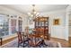 Dining room features a large window, hardwood floors, decorative chandelier, and built in cabinetry at 5945 Boulder Bluff Dr, Cumming, GA 30040