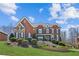 Beautiful brick home with meticulously maintained front yard, mature landscaping, and an inviting curb appeal at 5945 Boulder Bluff Dr, Cumming, GA 30040