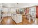 Gourmet kitchen featuring an island cooktop, stainless appliances, eat-in dining and views of the living area at 5945 Boulder Bluff Dr, Cumming, GA 30040