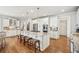 Open kitchen with a large island, stainless steel appliances, white cabinets, and hardwood floors at 5945 Boulder Bluff Dr, Cumming, GA 30040