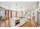 Open kitchen and living area with island, modern appliances, and hardwood floors at 5945 Boulder Bluff Dr, Cumming, GA 30040