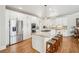 Bright kitchen with stainless steel appliances, island with seating, and hardwood floors at 5945 Boulder Bluff Dr, Cumming, GA 30040