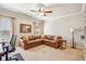 Living room with a leather couch, plush carpet, large windows, and an adjacent desk at 5945 Boulder Bluff Dr, Cumming, GA 30040
