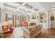 Bright living room with a fireplace, built-in shelves, and three large windows providing ample natural light at 5945 Boulder Bluff Dr, Cumming, GA 30040