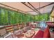 Relax on this covered back deck with ample seating, including a swing, and a pool view at 8540 Ridge Rd, Fairburn, GA 30213
