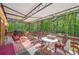 Relax on this covered back deck with ample seating and peaceful backyard views at 8540 Ridge Rd, Fairburn, GA 30213