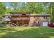 Expansive backyard featuring a two-story brick house, a deck, and a lush green lawn at 8540 Ridge Rd, Fairburn, GA 30213