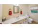 Bathroom with vanity, patterned floor, and window providing natural light at 8540 Ridge Rd, Fairburn, GA 30213