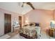 Bedroom featuring exposed beam, neutral carpeting, floral bedding, and natural light at 8540 Ridge Rd, Fairburn, GA 30213