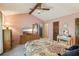 Bedroom featuring exposed beam, neutral carpeting, floral bedding, and natural light at 8540 Ridge Rd, Fairburn, GA 30213