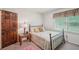Cozy bedroom with patterned bedding and a window providing natural light at 8540 Ridge Rd, Fairburn, GA 30213