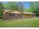 Attractive single-story home with a brick facade, complemented by a well-manicured lawn and simple landscaping at 8540 Ridge Rd, Fairburn, GA 30213